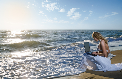 http://www.dreamstime.com/stock-photos-blond-girl-using-laptop-sea-image16885613